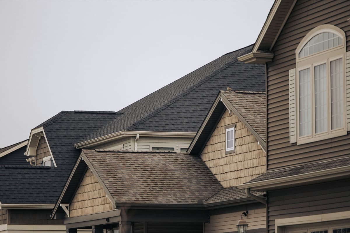 Houses with new shingle roofs and wood siding